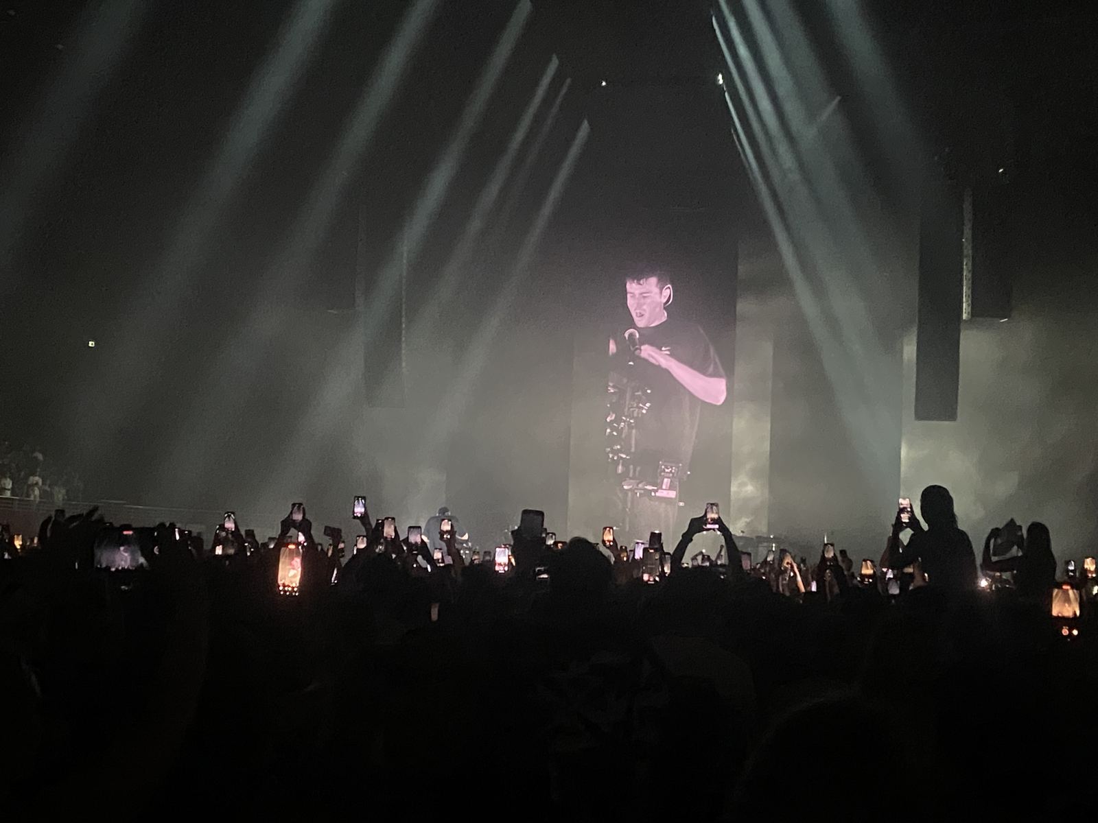 Arena crowd, phones up, from front of house